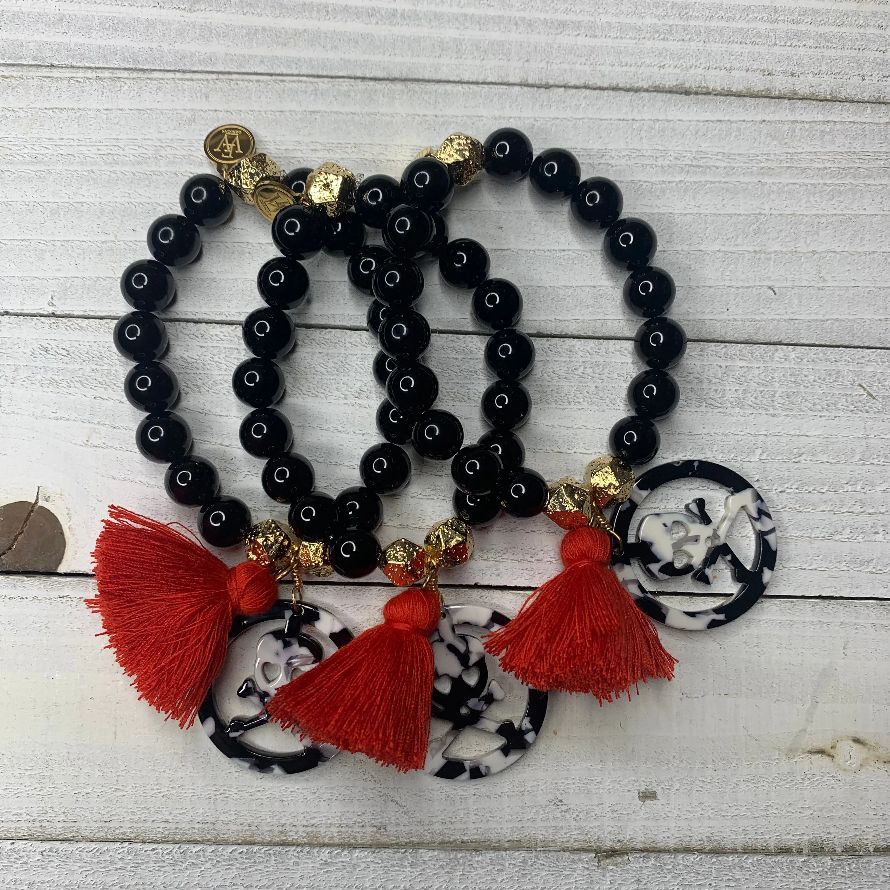 Black Agates with Acetate Skull Medallion and Red Tassel Bracelet 410-14 | Erika Williner Designs