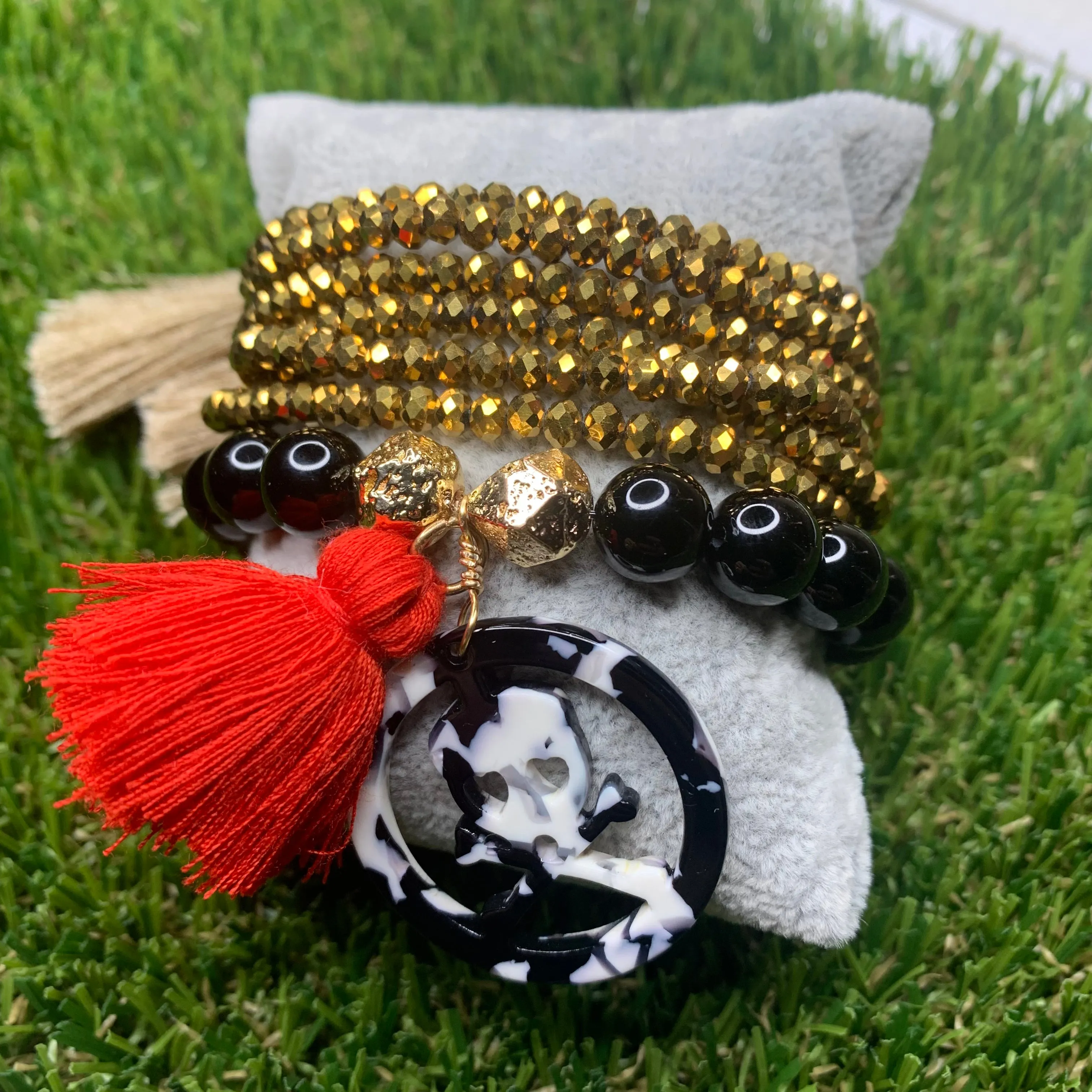 Black Agates with Acetate Skull Medallion and Red Tassel Bracelet 410-14 | Erika Williner Designs