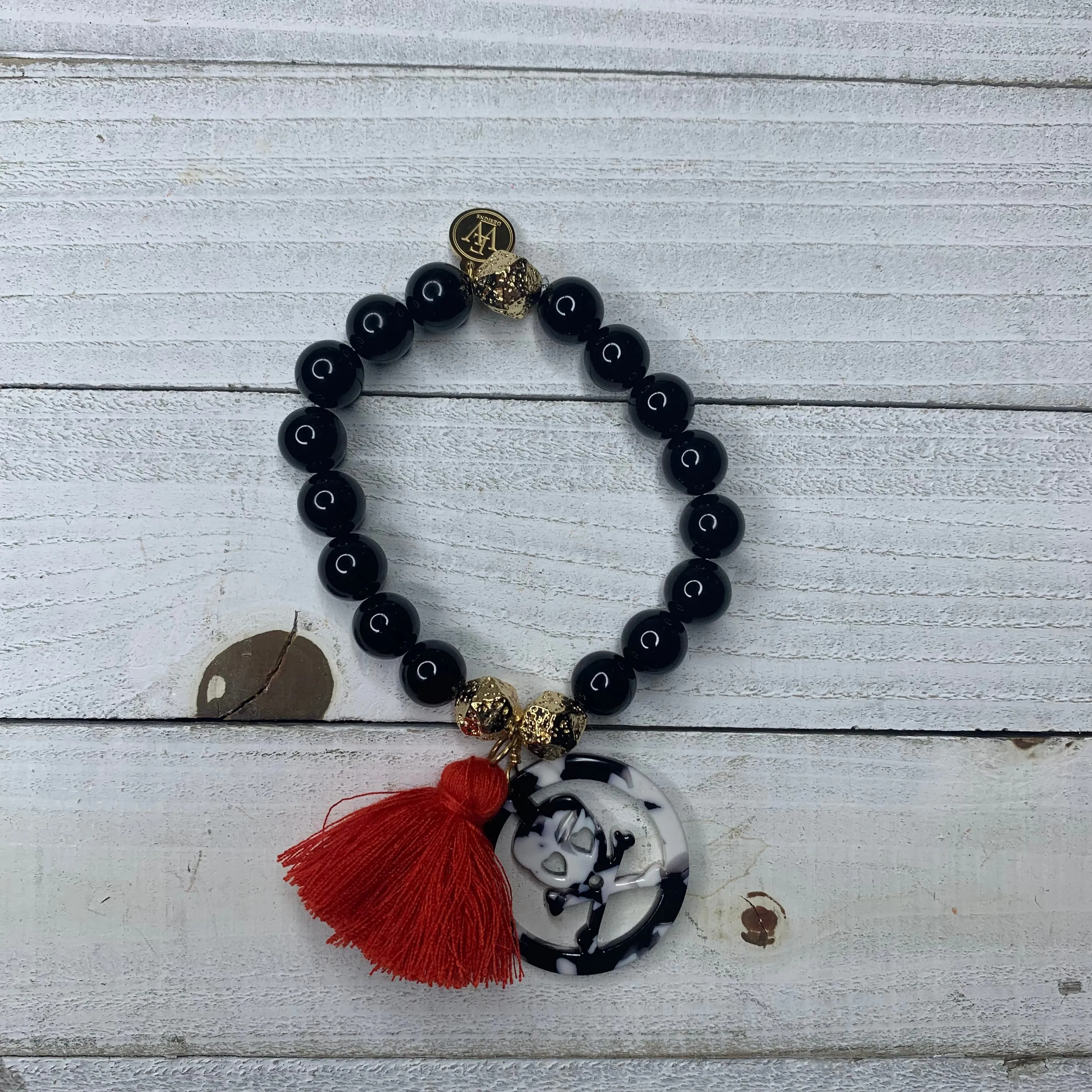Black Agates with Acetate Skull Medallion and Red Tassel Bracelet 410-14 | Erika Williner Designs
